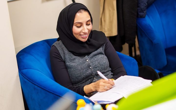 A Personal Homecare Pharmacy team member making notes in a pad